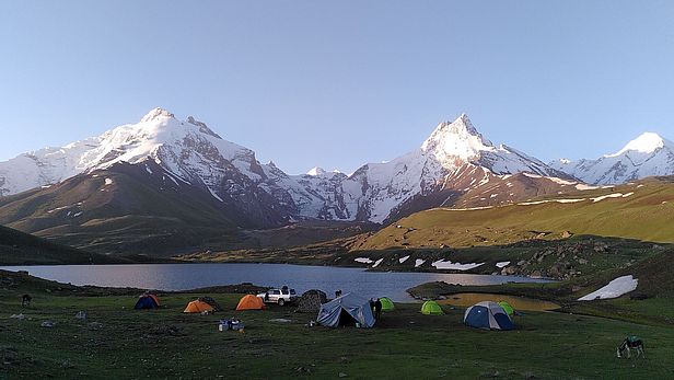 Base camp in the early morning (~5a.m.). Our debris-covered study glacier, Kyzylsu, terminates in the center of the photograph, on the opposite side of the lake. Photo: S. Fugger