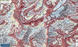 Topographic map showing mountains, valleys, and water bodies with zones highlighted in red and blue.