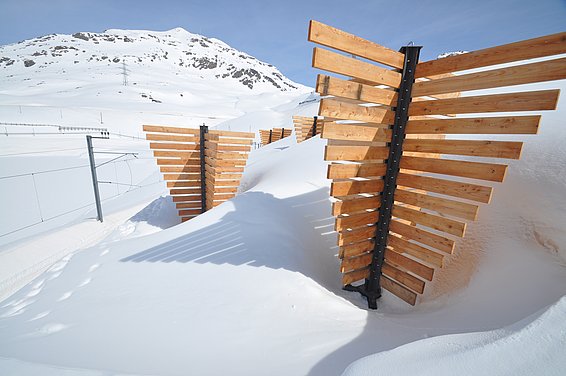 Wooden kolk crosses on snowy mountain under clear blue sky